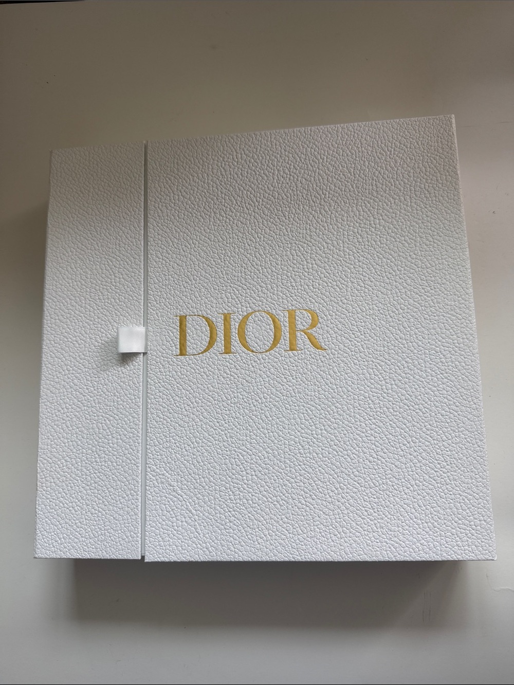 A Large Textured Christian Dior Gold Logo Gift Box With Ribbon Side Closure